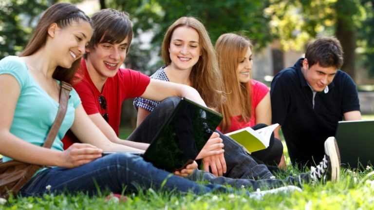 Group of college students studying at campus