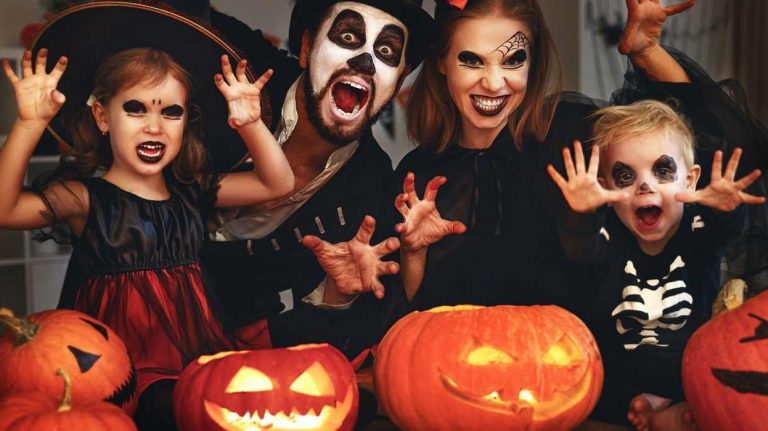 happy family mother father and children in costumes and makeup on  Halloween